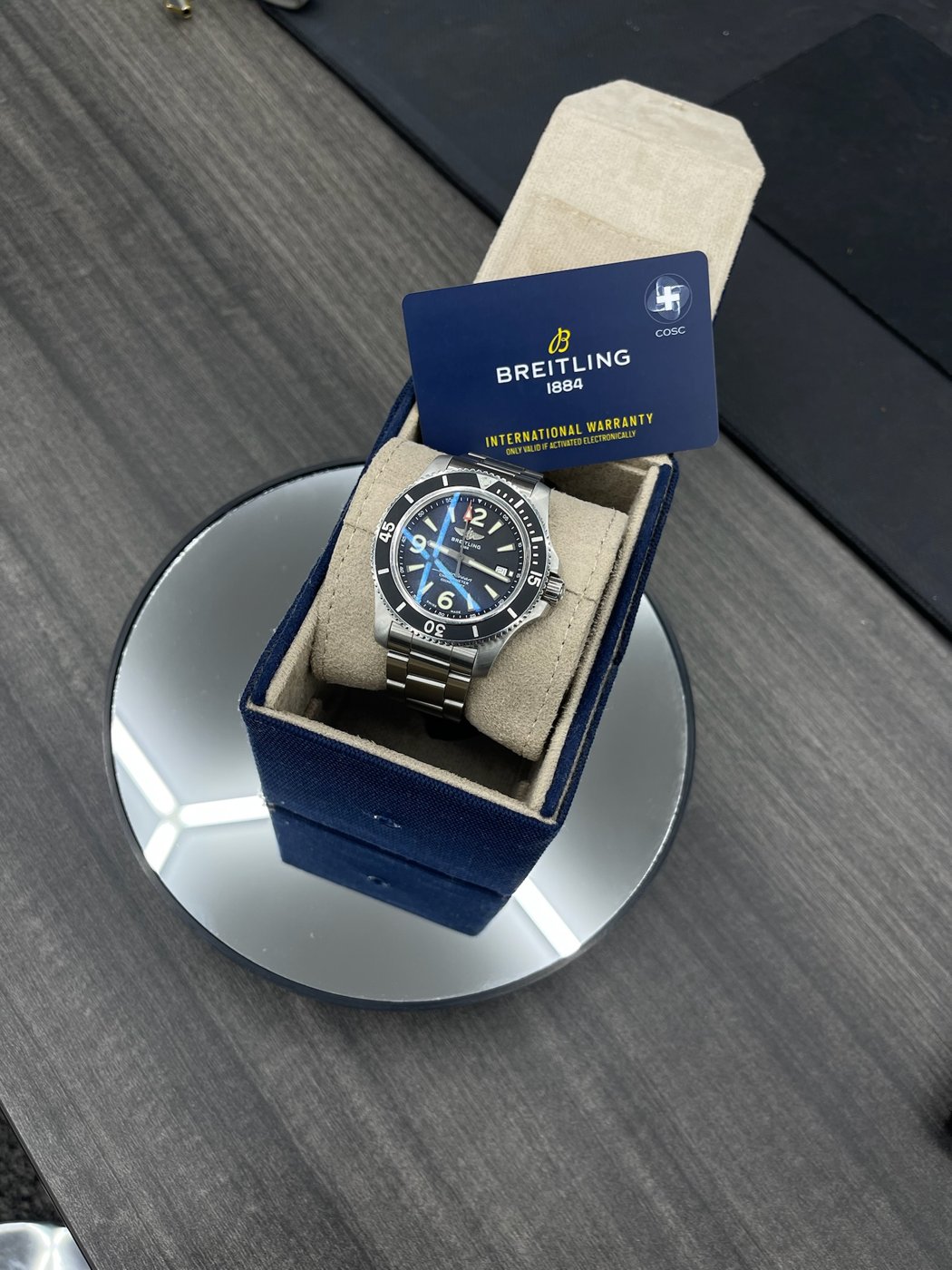 Boxed Breitling watch on a mirrored surface