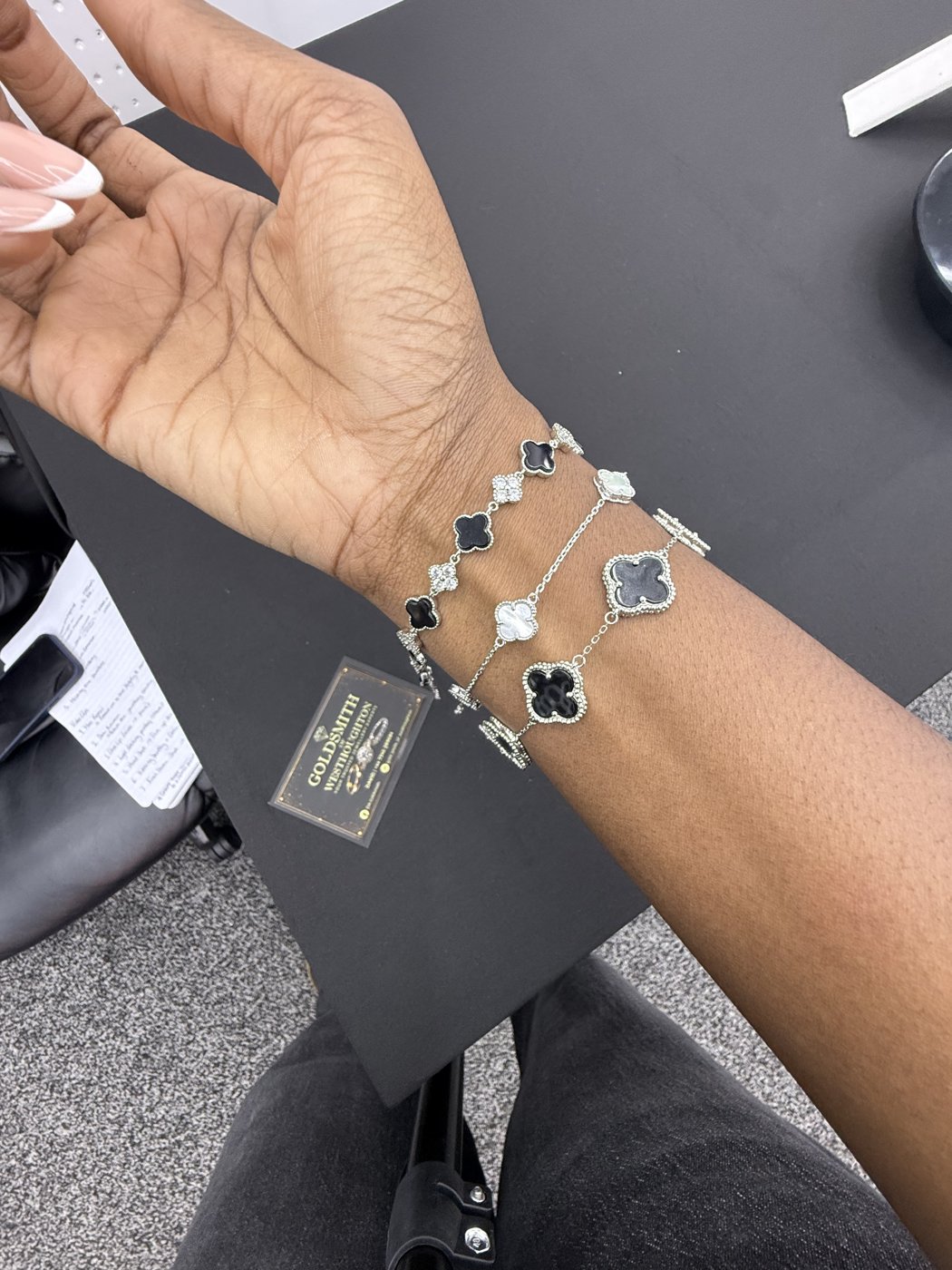 Bracelet with dark decorative motifs worn on a wrist