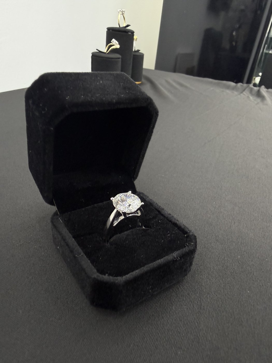 Solitaire ring in an open black jewellery box